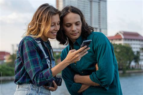 Cute Interracial Couple Looking At The Phone By Jovo Jovanovic