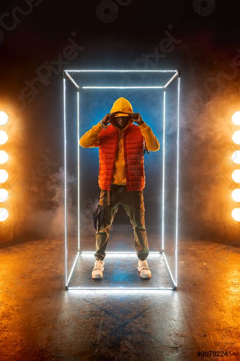 Stylish rapper poses in illuminated cube - stock photo 3078224 | Crushpixel