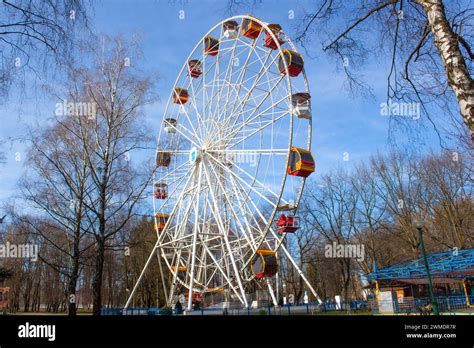 Ferris Wheel Featuring Colourful Seating Pods Against Backdrop Of Blue