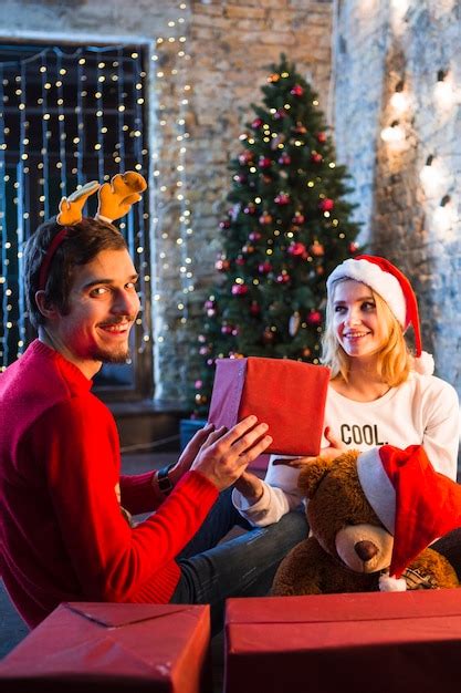 Free Photo | Happy couple in front of christmas tree