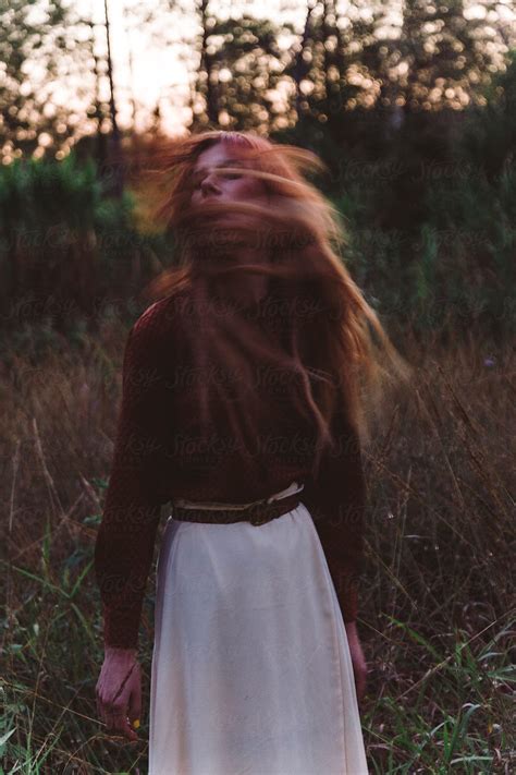 Young Girl Flipping Her Hair In Field By Stocksy Contributor Image