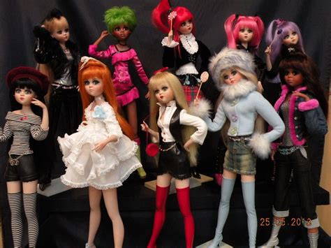 A Group Of Dolls Standing Next To Each Other