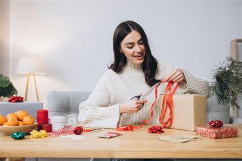 Premium Photo Woman Wrapping Christmas Presents Gifts