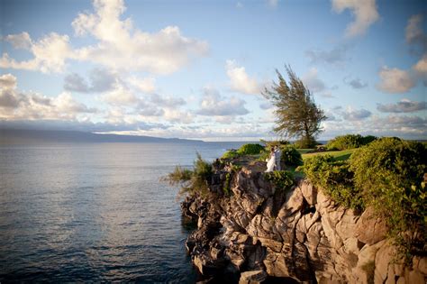 Couple Standing on Cliff Overlooking Ocean