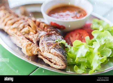 Fried Fresh Big Fish With Salad And Hot Spicy Sauce Thai Food Style