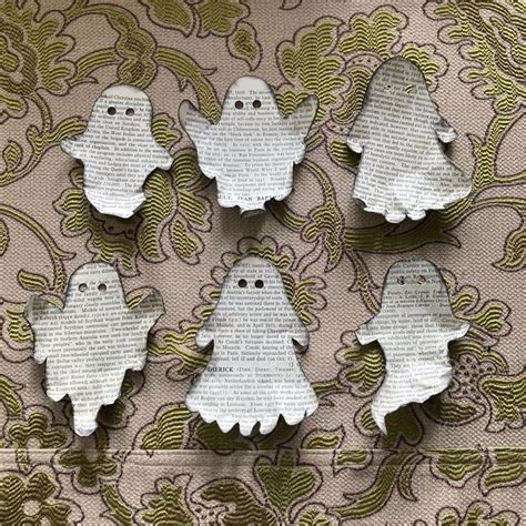 six ghost magnets are sitting on top of a sheet of paper with words ...