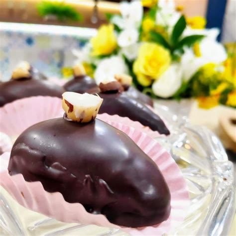 Three Chocolate Covered Desserts Sitting On Top Of A Glass Plate With