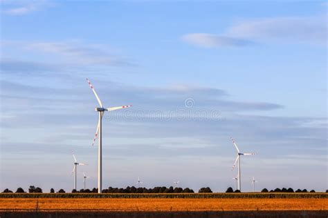 Wind Farm In The Field Wind Turbines Spin To Generate Electricity Alternative Energy And Green