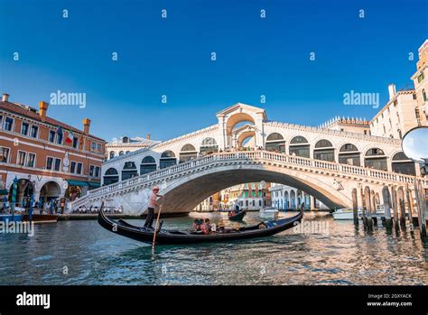 Traditional Gondola Near World Famous Canal Grande And Rialto Bridge