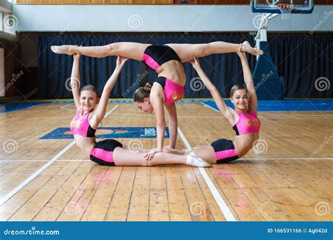 Cheerleaders Working Out In The Gym Girls Standing Upside Down