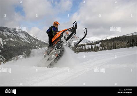 Man doing stunts on a snowmobile Stock Photo - Alamy