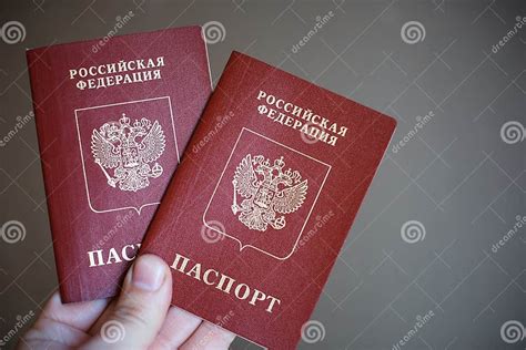 Two Russian Passports In Hand Russian Official Document On Black