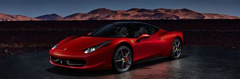 A Red Ferrari 458 Italia Standing In Front Of The Desert Dunes Engine