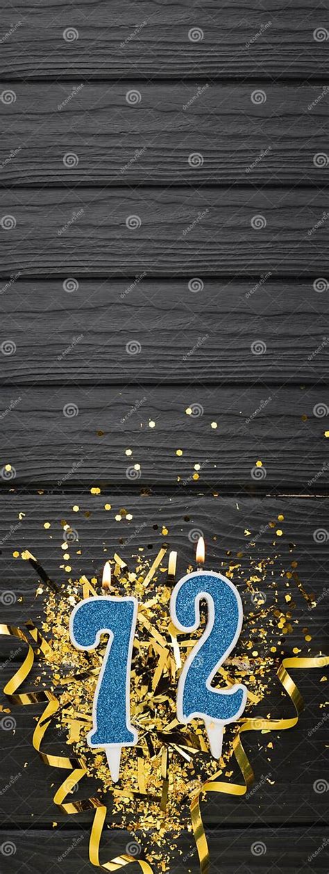 Number 72 Blue Celebration Candle And Gold Confetti On Dark Wooden