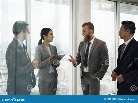 Business People Standing Discussing About The Meeting Stock Photo