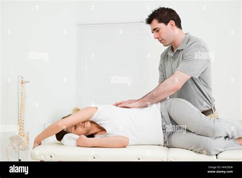 Brunette Woman Lying On The Side While Being Massaged In A Medical Room