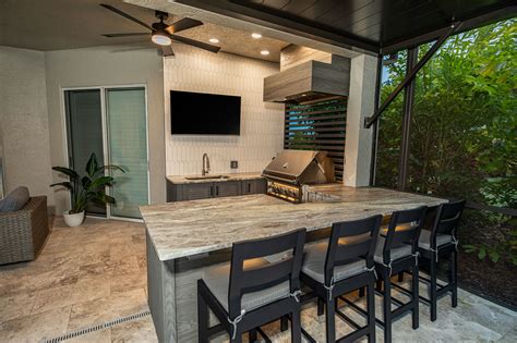 Custom Outdoor Kitchen With Gas Fire Pit And Landscape Lighting In