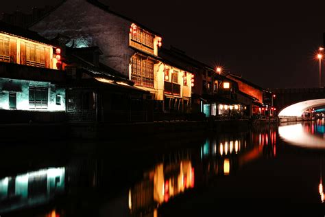 Brown And White Concrete Building Near Body Of Water During Night Time Photo Free China Image