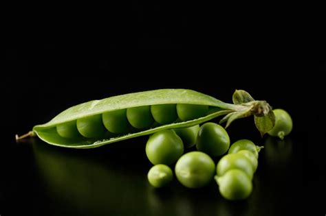 Premium Photo Pea Pods On A Black Background Green Peas In A Pod On