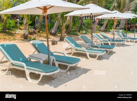 Beautiful Beach Chairs With Umbrella On Tropical White Sand Beach Stock