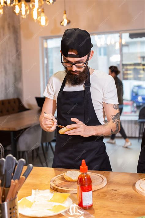 Premium Photo Male Chef Cooking Burger In Restaurant Kitchen
