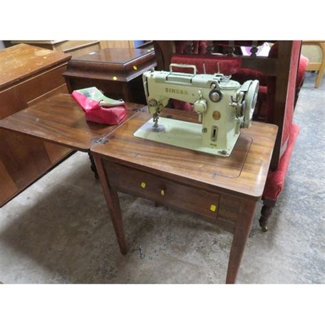 A Table Cased Singer Electric Sewing Machine