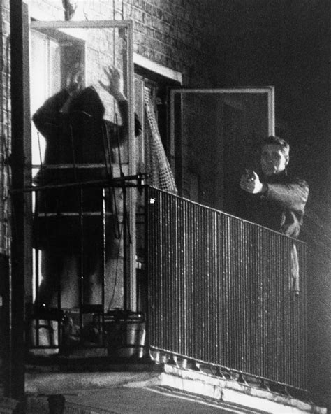 A member of the IRA surrenders to police at a flat at 22b Balcombe