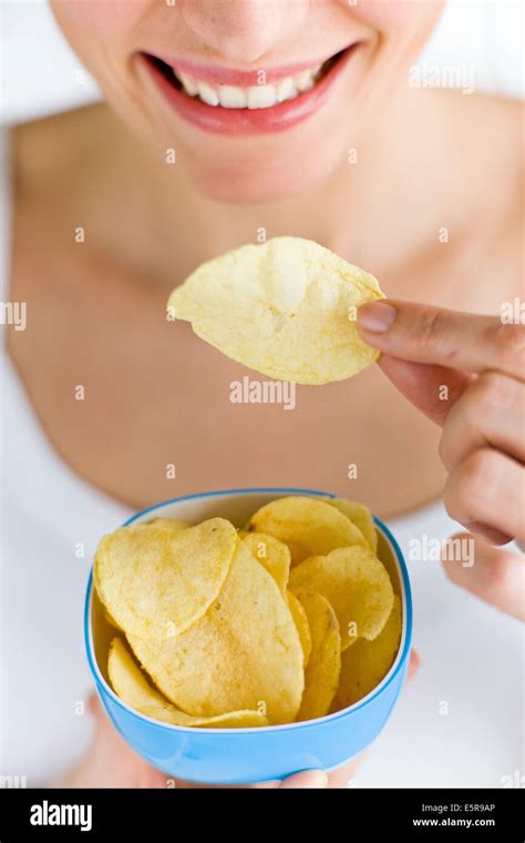 Woman Eating Potato Chips Stock Photo Alamy