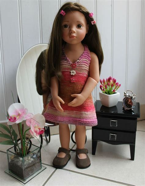 A Doll Is Standing Next To A Flower Pot