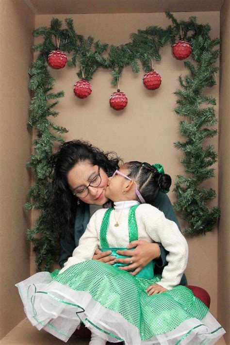 Mom With Her Year Old Brunette Daughter With Eyeglasses Inside A Decorated Gift Box To