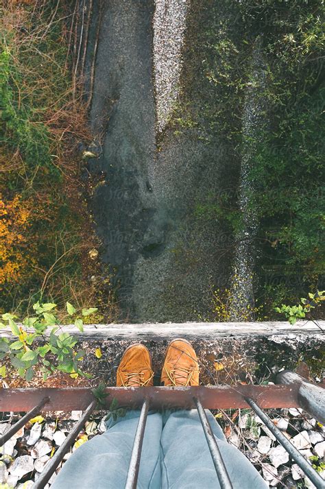 Man Standing On The Bridge Above The River Del Colaborador De Stocksy