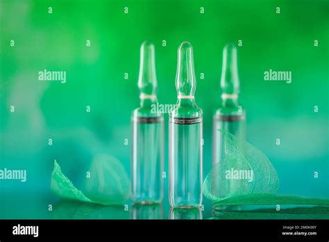 Transparent Ampoules Set And Green Skeletonized Leaves On A Turquoise