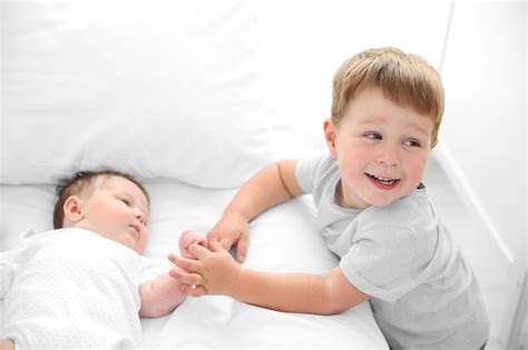 Premium Photo Small Brother And Sister On Bed