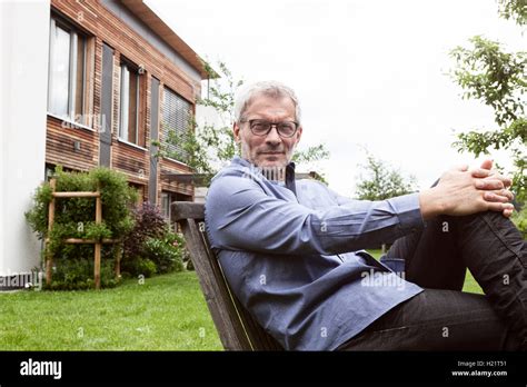 Portrait Of Confident Mature Man In Garden Stock Photo Alamy