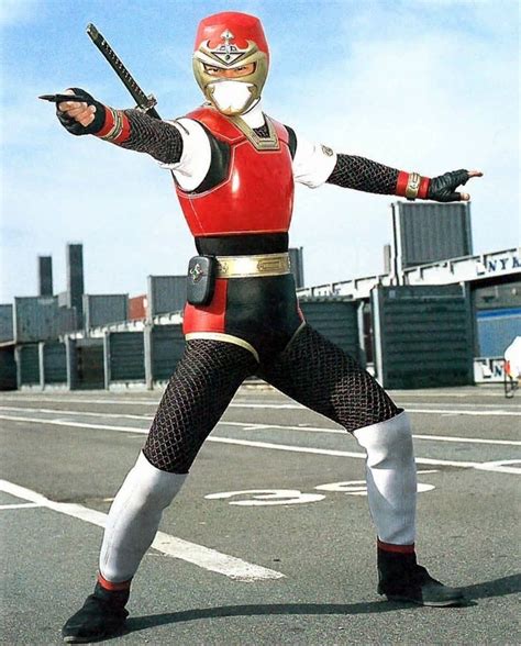 A Man In A Red And Black Power Ranger Costume