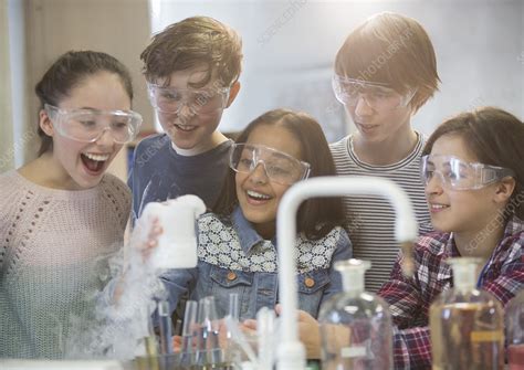 Students Conducting Scientific Experiment In Laboratory Stock Image