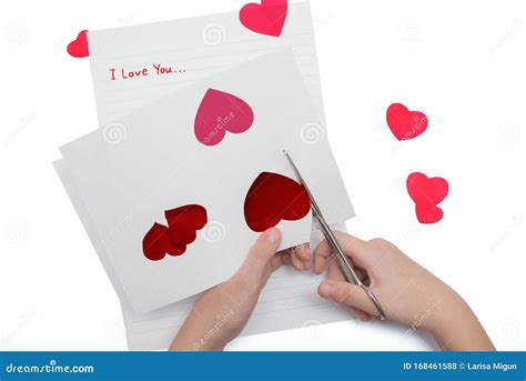 Scissor Cut Red Hearts Out Of Paper With The Words I Love You Stock