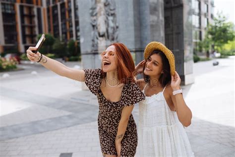 Two Joyful Girls Taking A Selfie On The City Street Stock Image Image