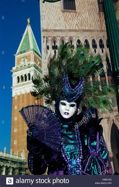 Costume With Peacock Feathers At Venice Carnival With St Marks Bell