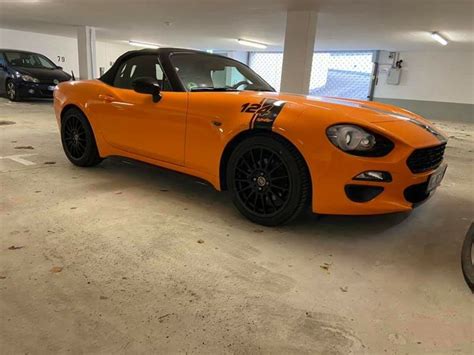 An Orange Sports Car Parked In A Parking Garage