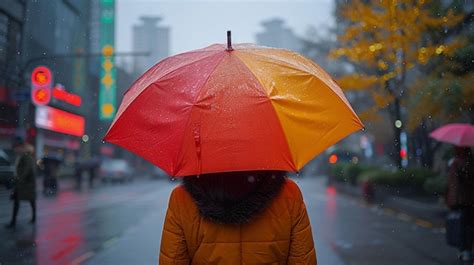 Premium Photo | Person standing in the rain holding an umbrella