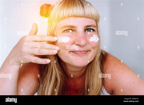 Portrait Attractive Middle Aged Blonde Woman With Cosmetic Cream Stock