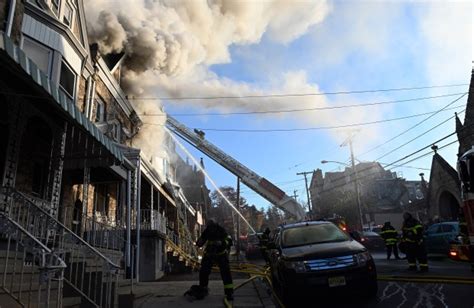 Reading fire crews battling 2-alarm row house fire