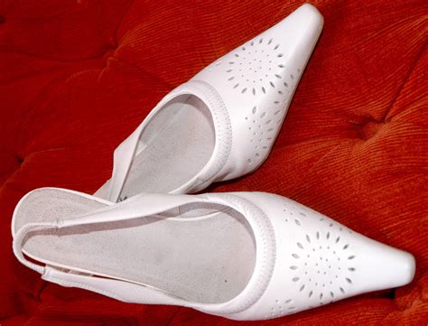 White perforated slingback shoes on orange fabric Free Stock Photo ...