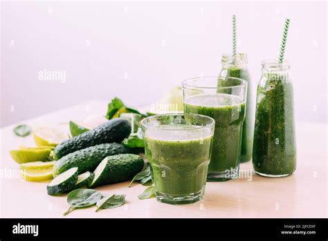 Green Vegetable Fruit Smoothie In Various Glasses Portion Bottles On