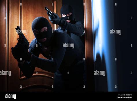 Armed Thieves Entering A House Stock Photo Alamy