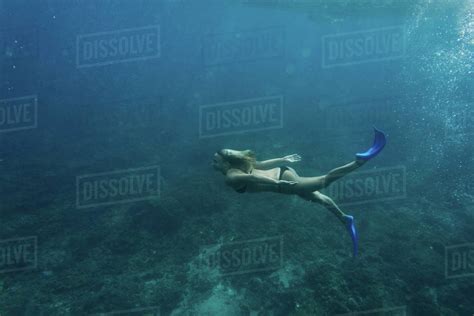 Side View Of Woman In Bikini And Flippers Diving In Ocean Alone Royalty Free Stock Photo