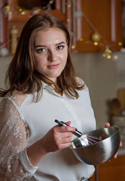 Premium Photo A Girl Prepares A Cream For A Festive Christmas Cake In