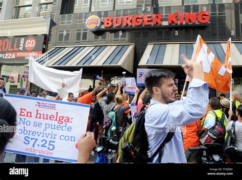 People Hold Up Signs Protesting The Low Wages For Workers At Fast Food