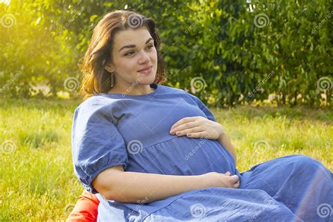 Beautiful Pregnant Girl Sitting In The Park Positive Pregnant Summer